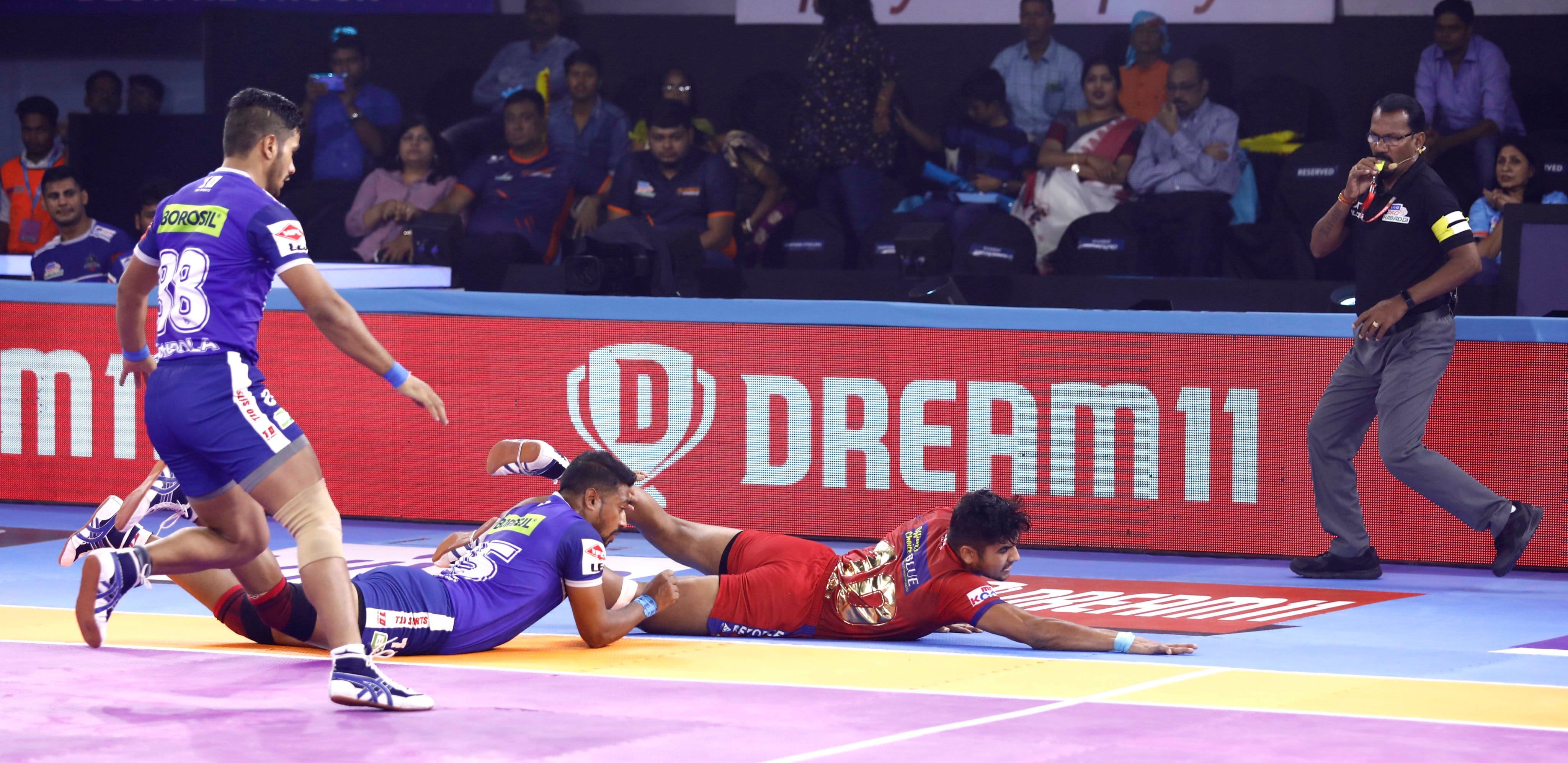 Naveen Kumar is thrown off the mat by Vikas Kale