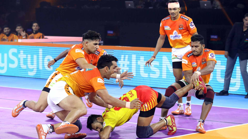 Pune's Surjeet and Girish Ernak tackling a Gujarat player